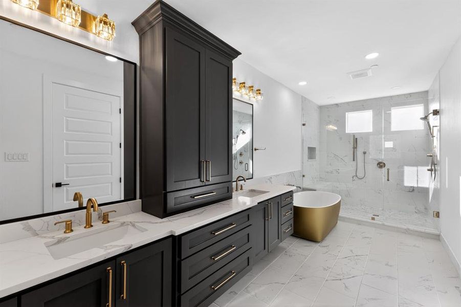 Bathroom featuring double vanity, a marble finish shower, a soaking tub, recessed lighting, and light marble finish floors