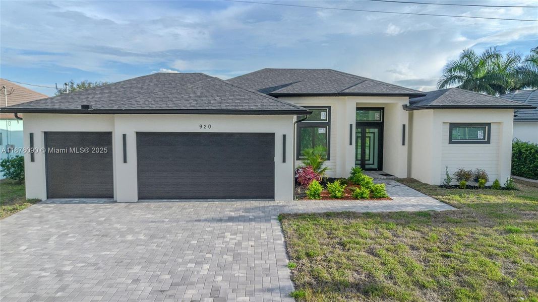 Front exterior of a new home in , Cape Coral, FL, highlighting curb appeal (Image 1).