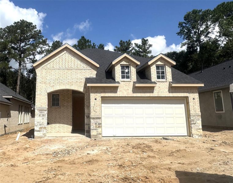 Front exterior of a new home in Woodhavyn 40', Magnolia, TX, highlighting curb appeal (Image 1).