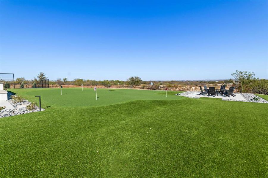 View of area practice putting, a lawn, and a patio View of area practice putting, a lawn, and a patio