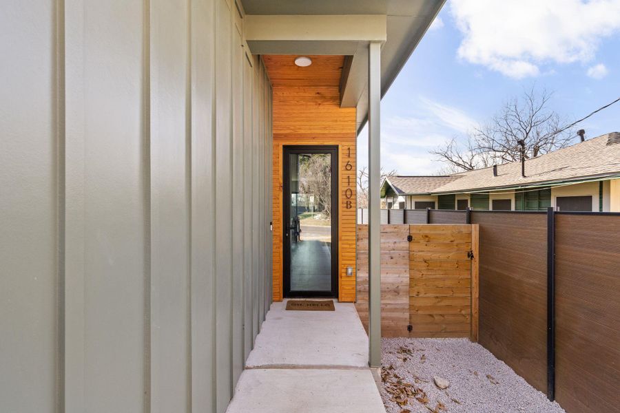 Doorway to property featuring a gate and board and batten siding