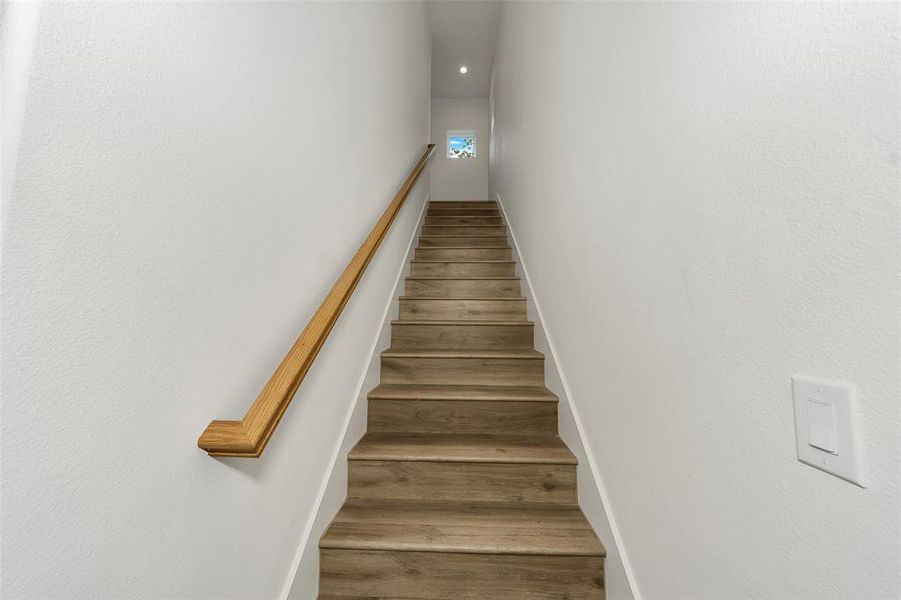 Stairway featuring wood finished floors and recessed lighting Stairway featuring wood finished floors and recessed lighting