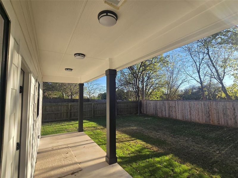 Fenced backyard with a patio