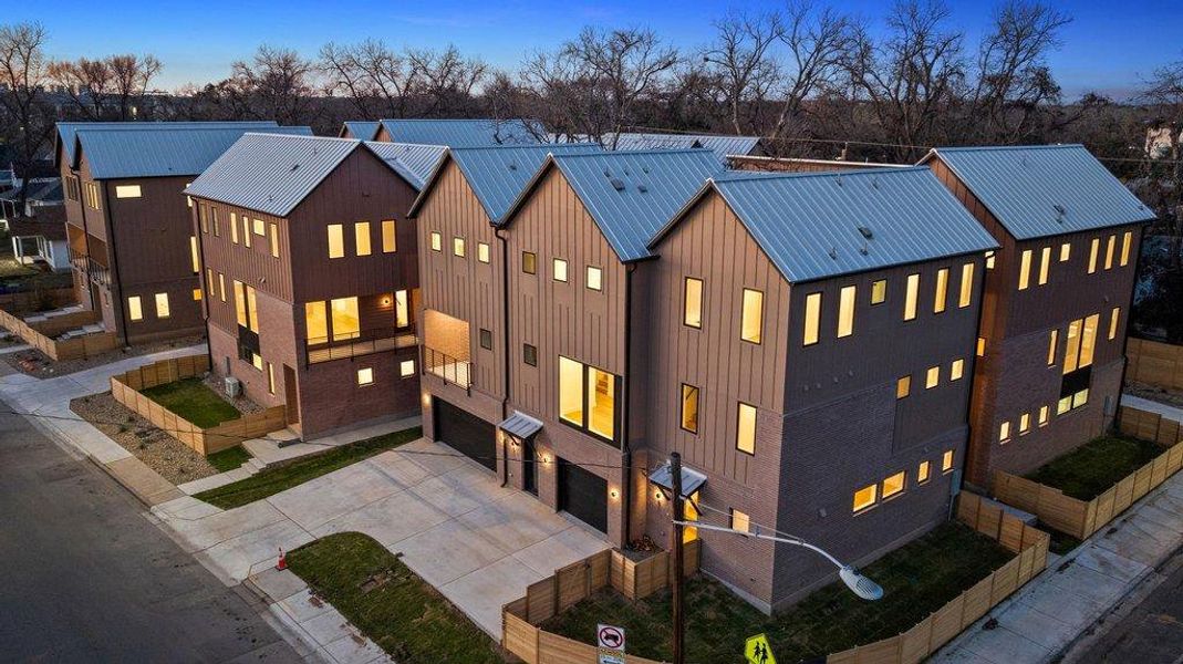 Contemporary facades with angular roofs define these modern residences.