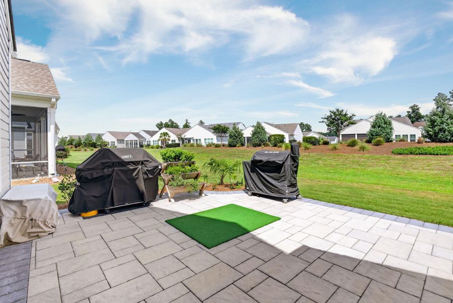 Exterior details and patio area of a home in K. Hovnanian's® Four Seasons at Lakes of Cane Bay, Summerville (Image 26).