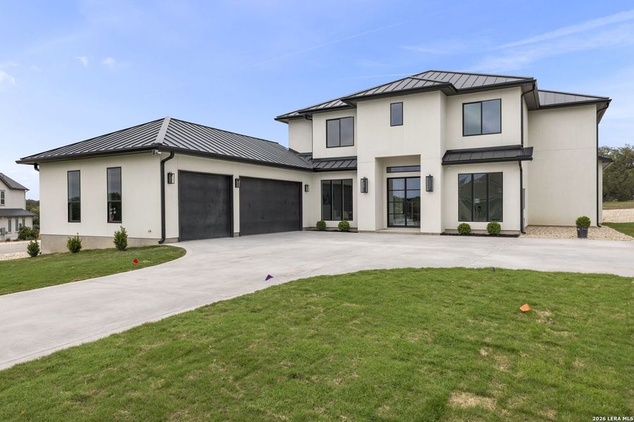 Front exterior of a new home in , Bulverde, TX, highlighting curb appeal (Image 26).