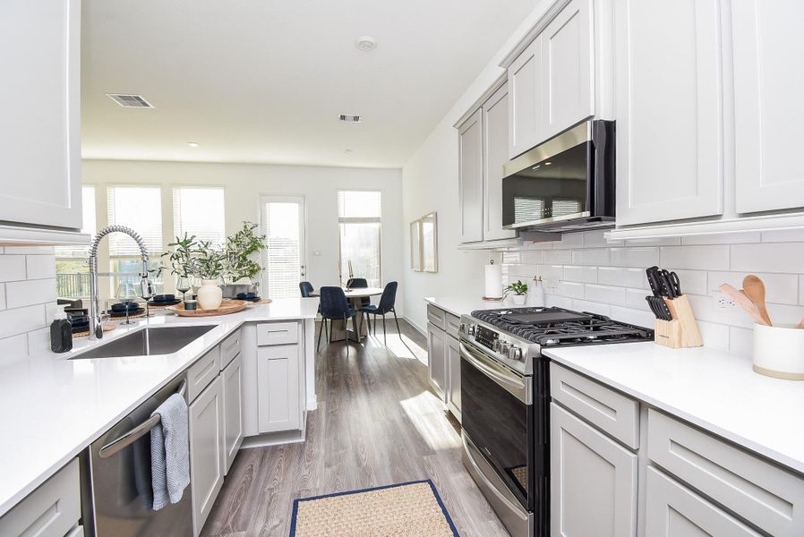 A wide-angle view of the kitchen and adjacent dining space for a harmonious flow.