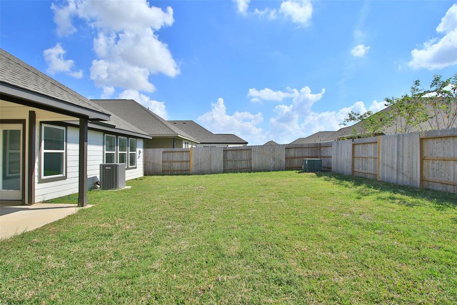 Exterior details and patio area of a home in Sunterra, Katy (Image 2).