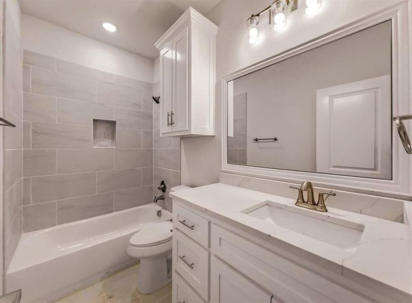 Full bathroom featuring vanity, tub / shower combination, and recessed lighting Full bathroom featuring vanity, tub / shower combination, and recessed lighting