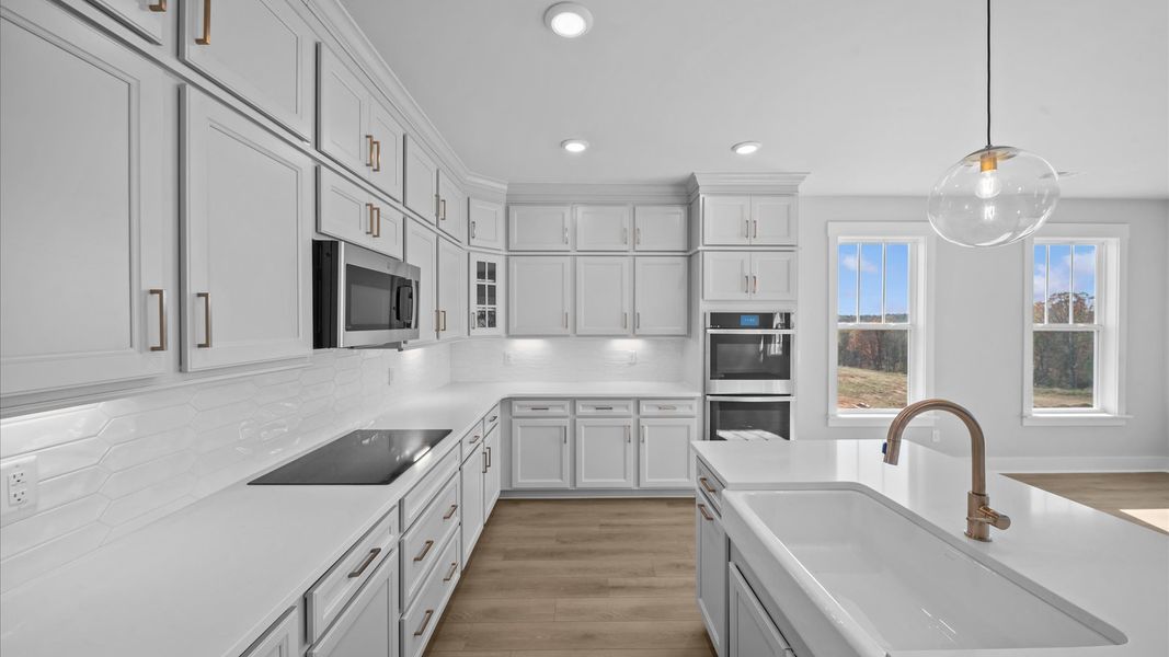 Notable 8-foot island provides generous prep and gathering space in this thoughtfully designed gourmet kitchen