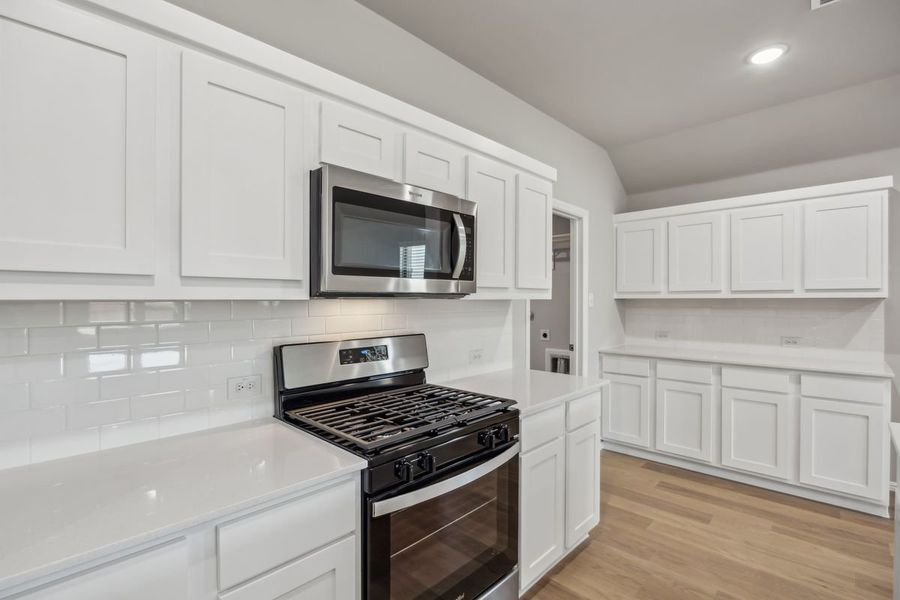 Kitchen in the Sabrina home plan by Trophy Signature Homes – REPRESENTATIVE PHOTO