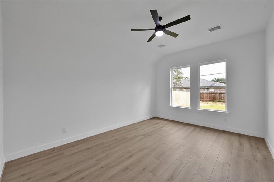 Primary bedroom with big windows.