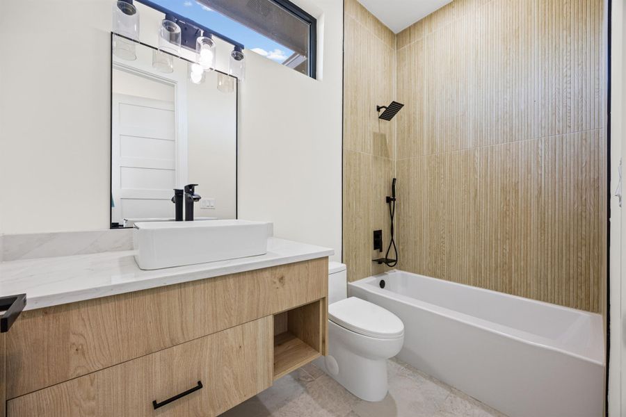 Bathroom featuring vanity and shower / washtub combination