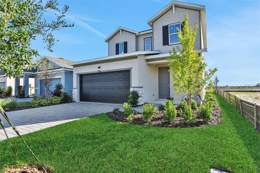Front exterior of a new home in Turnleaf, Punta Gorda, FL, highlighting curb appeal (Image 1). Front exterior of a new home in Turnleaf, Punta Gorda, FL, highlighting curb appeal (Image 1).