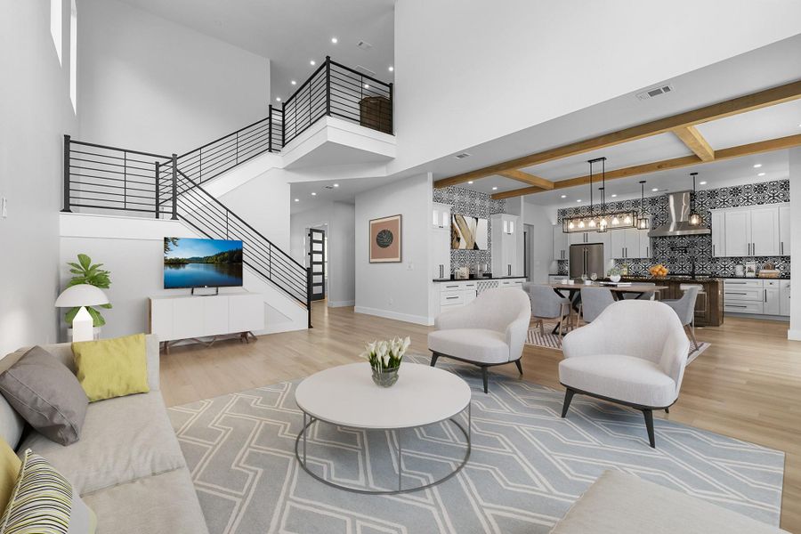 Living room featuring stairs, a high ceiling, light wood finished floors, and recessed lighting Living room featuring stairs, a high ceiling, light wood finished floors, and recessed lighting