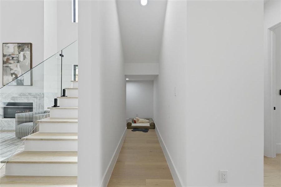 Modern staircase with clear glass railing and black hardware Modern staircase with clear glass railing and black hardware