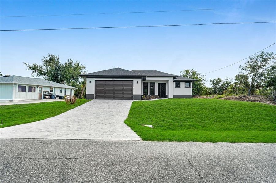 Front exterior of a new home in , Englewood, FL, highlighting curb appeal (Image 17).