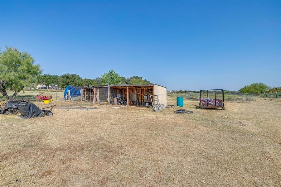 View of jungle gym with an outbuilding, exterior structure, and a patio area View of jungle gym with an outbuilding, exterior structure, and a patio area