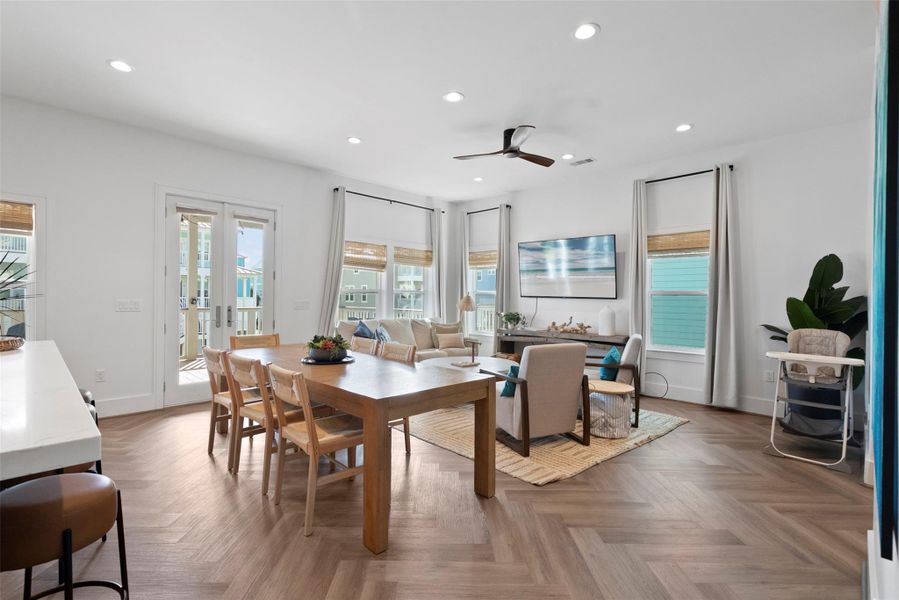 Breezy and bright, this open-concept kitchen, dining, and living area captures the essence of Modern Coastal living—natural textures, airy neutrals, and subtle organic elements come together in a clean, contemporary layout, enhanced by large windows and a door that invite natural light and outdoor views. Breezy and bright, this open-concept kitchen, dining, and living area captures the essence of Modern Coastal living—natural textures, airy neutrals, and subtle organic elements come together in a clean, contemporary layout, enhanced by large windows and a door that invite natural light and outdoor views.