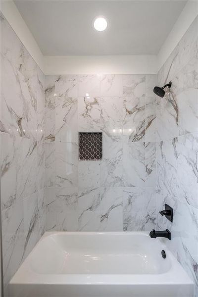 Bathroom featuring tiled shower / bath