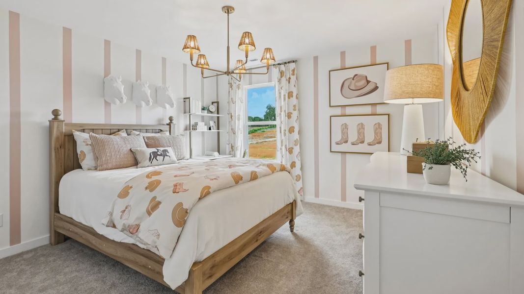 Secondary bedroom with carpet, closet, and window