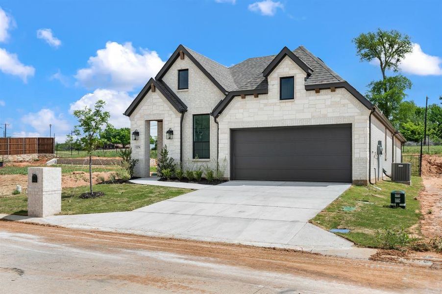 Front exterior of a new home in The Resort on Eagle Mt. Lake, Fort Worth, TX, highlighting curb appeal (Image 2). Front exterior of a new home in The Resort on Eagle Mt. Lake, Fort Worth, TX, highlighting curb appeal (Image 2).