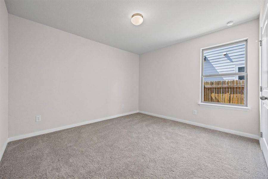 Soft carpeting pairs with a bright window overlooking the fenced yard in this versatile room. Soft carpeting pairs with a bright window overlooking the fenced yard in this versatile room.
