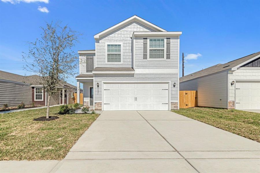 This beautiful two-story features a modern exterior design with beautiful LP siding and stone.