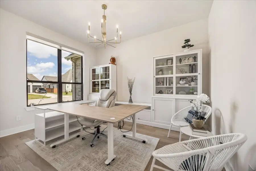 PRIVATE HOME OFFICE OFFERS A LARGE FRONT-FACING WINDOW, WOOD FLOORING, AND PLENTY OF SPACE FOR A FUNCTIONAL WORK-FROM-HOME SETUP. PRIVATE HOME OFFICE OFFERS A LARGE FRONT-FACING WINDOW, WOOD FLOORING, AND PLENTY OF SPACE FOR A FUNCTIONAL WORK-FROM-HOME SETUP.