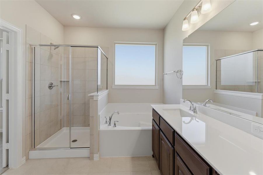 Bathroom with vanity, a bath, a stall shower, recessed lighting, and light tile patterned floors
