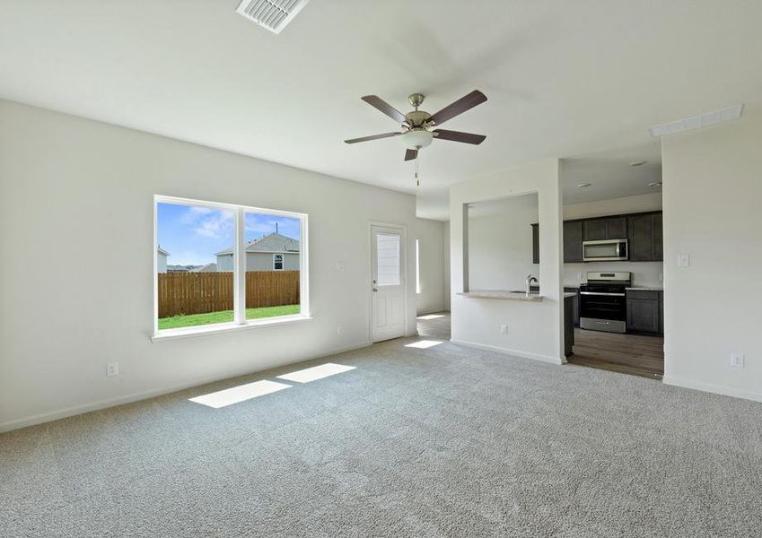 The open-concept layout of this floor plan has the kitchen, family room and dining room sitting next to one another.