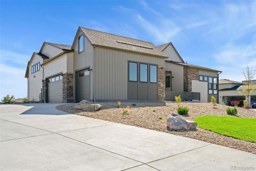 Front exterior of a new home in Acadia at RainDance, Windsor, CO, highlighting curb appeal (Image 18).