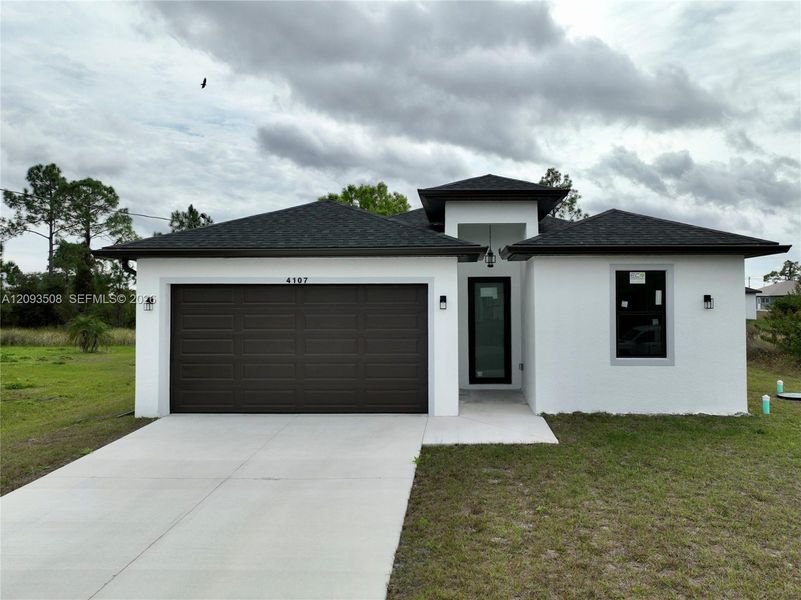 Front exterior of a new home in , Lehigh Acres, FL, highlighting curb appeal (Image 18).