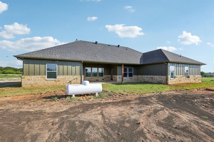 Rear view of property featuring a patio area