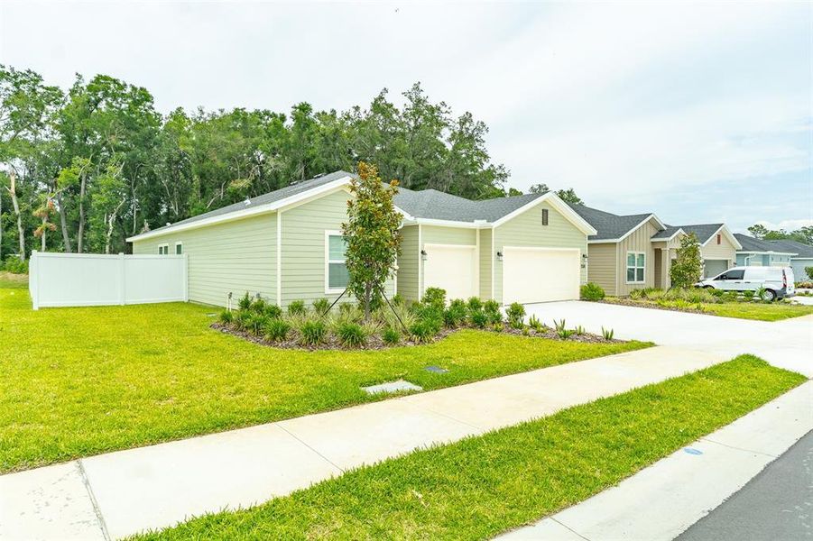 Front exterior of a new home in Pioneer Ranch, Ocala, FL, highlighting curb appeal (Image 21). Front exterior of a new home in Pioneer Ranch, Ocala, FL, highlighting curb appeal (Image 21).