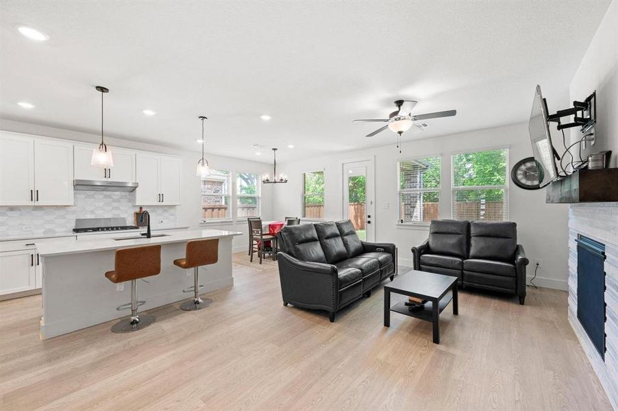 Open-concept living space with light wood-finish flooring Open-concept living space with light wood-finish flooring