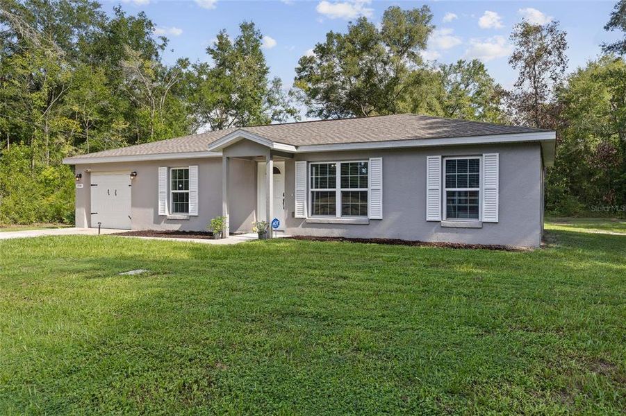 Front exterior of a new home in , Williston, FL, highlighting curb appeal (Image 20).