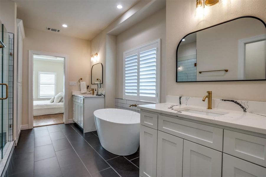 Bathroom featuring tile patterned flooring, vanity, and independent shower and bath