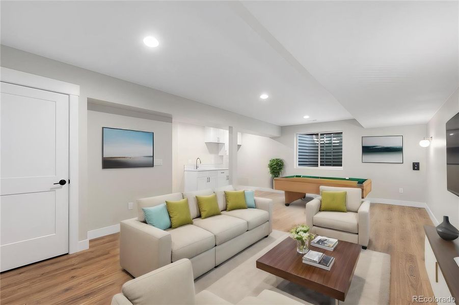 Spacious lower level living and rec room withfull wet bar (virtually staged to show designoptions) Spacious lower level living and rec room withfull wet bar (virtually staged to show designoptions)