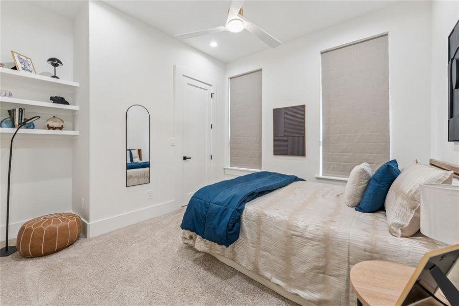 Large bedroom with ceiling fan and custom built in closet Large bedroom with ceiling fan and custom built in closet