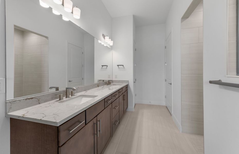 Owner's bathroom with dual-sink vanity and spacious shower