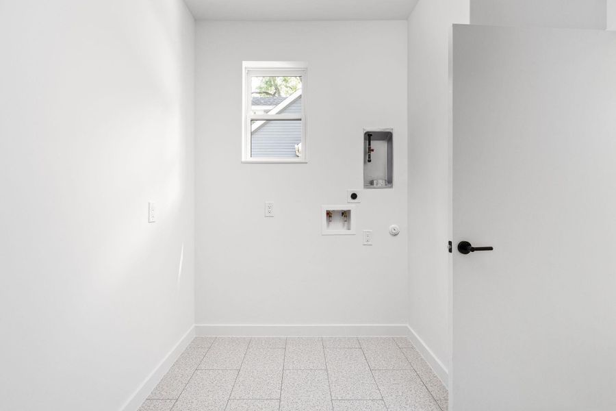 Laundry room with electric dryer hookup, hookup for a washing machine, and gas dryer hookup Laundry room with electric dryer hookup, hookup for a washing machine, and gas dryer hookup