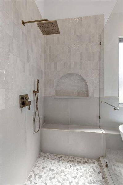 Full bath featuring a tile shower and tile patterned floors