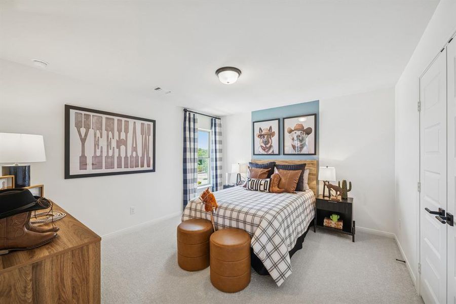 Bedroom with light gray carpeting and white walls