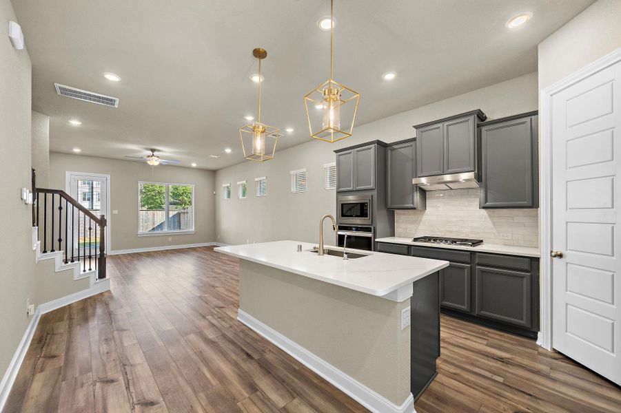 This modern, open-concept kitchen offers a seamless flow to the dining and living areas, perfect for both cooking and entertaining. This modern, open-concept kitchen offers a seamless flow to the dining and living areas, perfect for both cooking and entertaining.