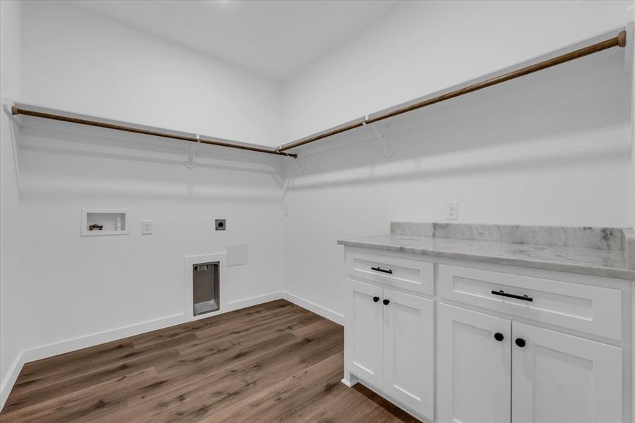 Laundry area featuring hookup for an electric dryer, dark wood-style flooring, hookup for a washing machine, and cabinet space Laundry area featuring hookup for an electric dryer, dark wood-style flooring, hookup for a washing machine, and cabinet space