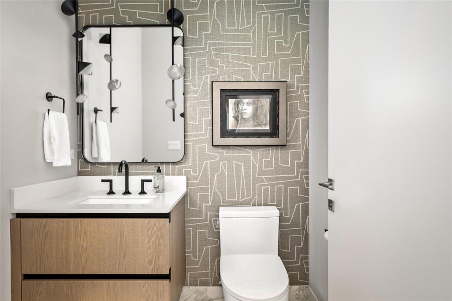 Chic Guest Half-Bath with Modern Fixtures and Designer Accents.