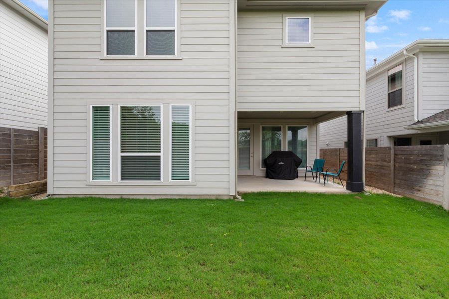Back of property with a fenced backyard and a patio
