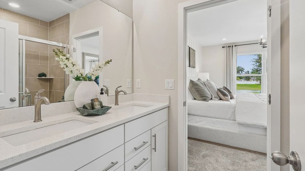 Primary Suite En Suite Bathroom with Dual Sinks in the Flagler Floorplan by DRB Homes Primary Suite En Suite Bathroom with Dual Sinks in the Flagler Floorplan by DRB Homes