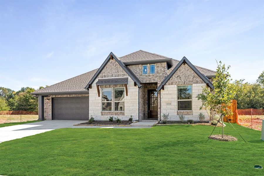 Front exterior of a new home in East Oak Creek 60-65, Commerce, TX, highlighting curb appeal (Image 2).
